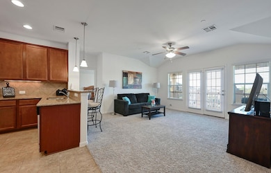 Kitchen featuring light carpet, visible vents, a 