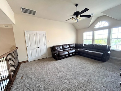 Living/game with ceiling fan and high eilincg