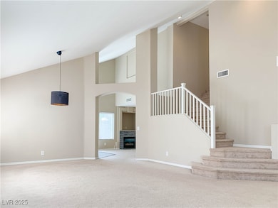 Unfurnished living room with high vaulted ceiling,