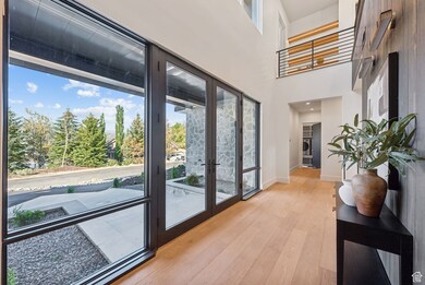 Doorway featuring healthy amount of natural light, wood finished floors, a high ceiling, and washer / clothes dryer