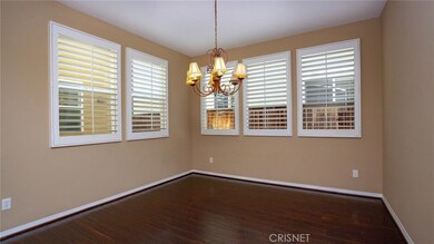 Formal dining room overlooks the brick patio and one of two fountains.