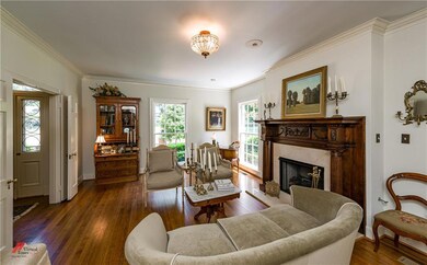 Pretty light filled living area with heavy crown m