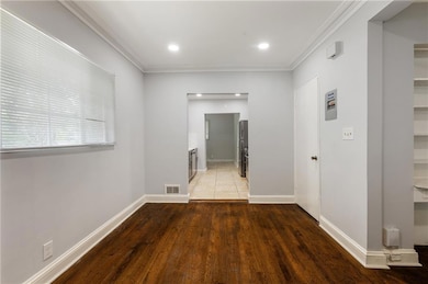 Hallway featuring crown molding, light wood-style floors, and recessed lighting