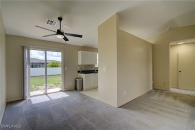 Unfurnished living room featuring light colored ca