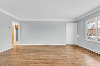 Empty room with light hardwood / wood-style floors