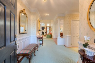 Foyer with Hardwood and custom carpet.
