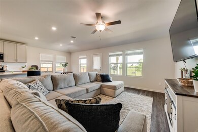 Living room featuring dark hardwood / wood-style flooring and ceiling fan