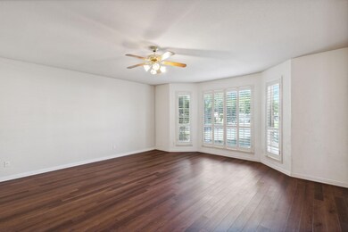 Spare room featuring ceiling fan and dark hardwood / wood-style flooring