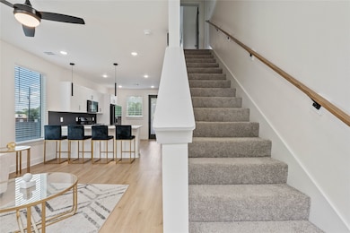 Interior view featuring the staircase leading to two bedrooms and a full bath.