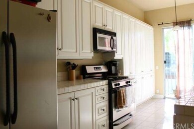 Bright kitchen with white tile counters and lots o