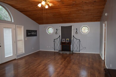 Den with vaulted ceiling could be used as a Master bedroom.  There is an attached full bath and large closet.  Electric fireplace does not stay. 