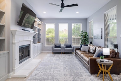 Living area featuring wood finished floors, a cei