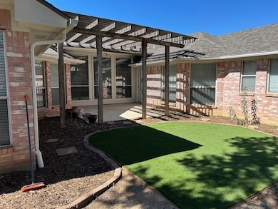 View of yard with a pergola and a patio area