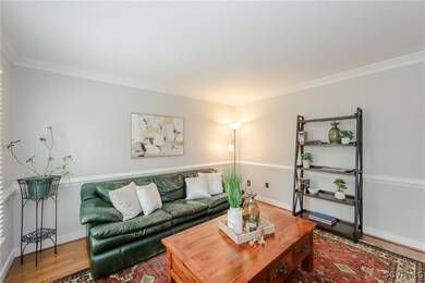 Living room featuring wood finished floors, basebo