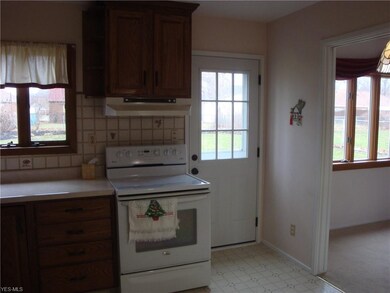 KITCHEN REAR DOOR. LOTS OF WINDOWS. BRIGHT AND AIR