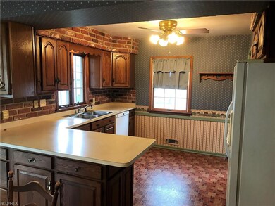 Spacious eat-in kitchen has lighted ceiling fan.