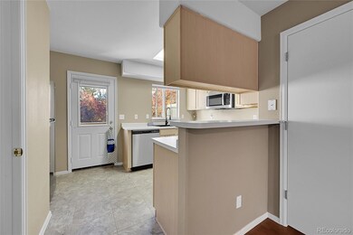 The upgraded kitchen features recessed lighting, access to the brand new deck and view of green space