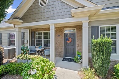 Doorway to property with a porch and brick siding