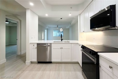 Kitchen featuring appliances with stainless steel finishes, ceiling fan, white cabinetry, and recessed lighting