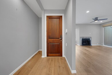 An entryway with a wooden door and sleek hardware