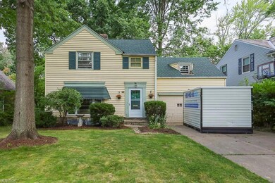 View of front of home with garage and a front lawn