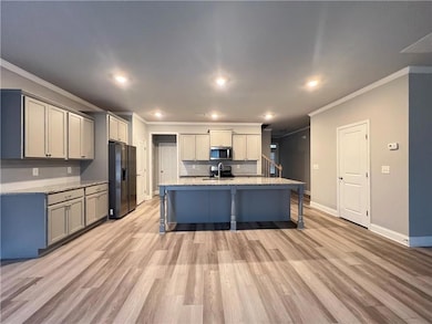 Kitchen featuring stainless steel microwave, a sin