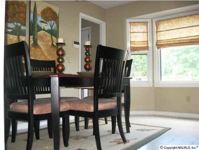 Bay window overlooks the new deck and well maintained back yard