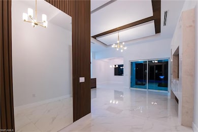 Hall featuring a notable chandelier