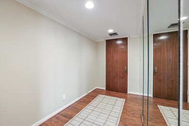 Interior entry with coat closet behind the mirrore