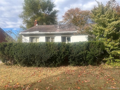 View of property exterior with a yard and a chimney