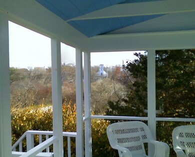Porch with view of church across wetland