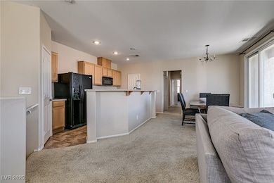 Kitchen featuring black appliances, light colored