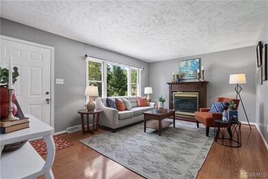 Living room featuring a textured ceiling and hardw