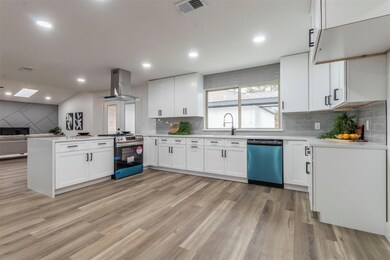 Kitchen featuring island range hood, stainless ste