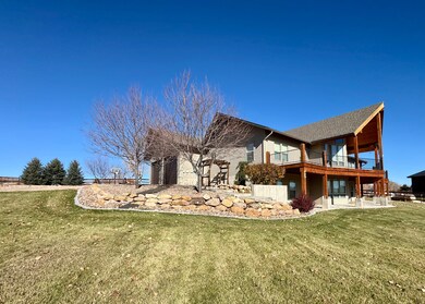 Rear view of property featuring a patio, a lawn, and a wooden deck