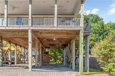 View of community featuring a carport, a deck, and stairs