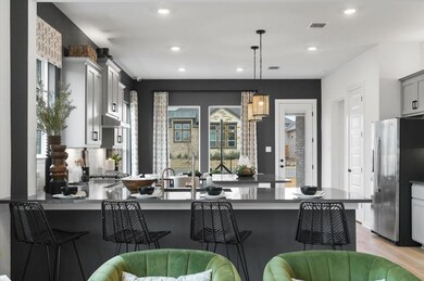 Kitchen featuring stainless steel fridge with ice