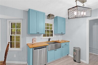 Kitchen featuring a sink, blue cabinets, and stain