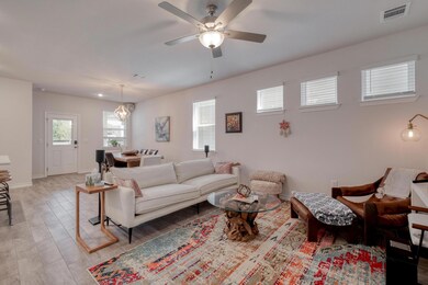 Living area with ceiling fan, light wood-type flo