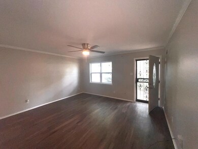 Spare room featuring ceiling fan, crown molding, and dark hardwood / wood-style flooring