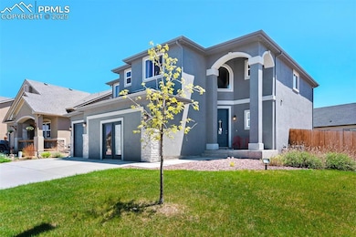 View of front facade featuring stucco siding, driveway, and an attached garage