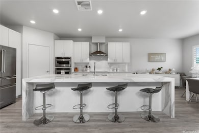 Gourmet kitchen features a dramatic waterfall isla
