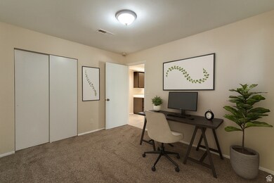 Home office with carpet and baseboards