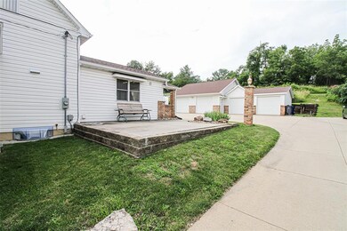 Side of house with cement patio.