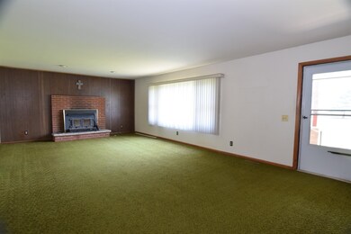 Upon entering the home you are welcomed into the living room.  This space is Huge 26x16!  There is a large picture window overlooking the front yard and under the carpeting in this room is hardwood flooring.