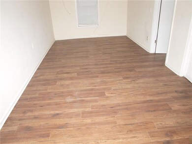 Spare room featuring baseboards and wood finished 