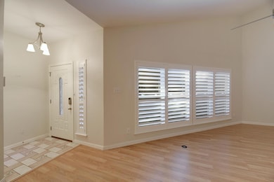 Foyer entrance with wood finished floors and a ch