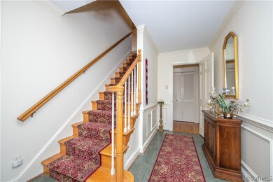 Foyer with slate floor, crown molding & chair rail