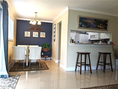 Tiled dining space with baseboards, a notable chan