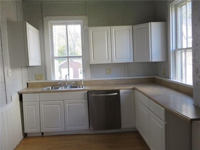 The White Cabinetry and 2 Windows Make the Kitchen